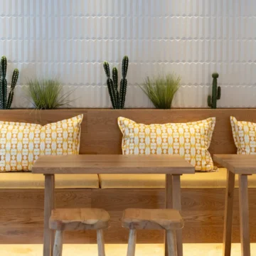Dining room with wooden tables, chairs and sofa